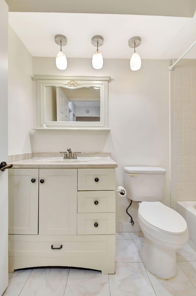 bathroom featuring vanity, toilet, and tub / shower combination