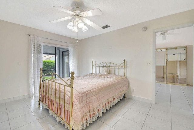 bedroom with light tile patterned floors, visible vents, ceiling fan, and baseboards