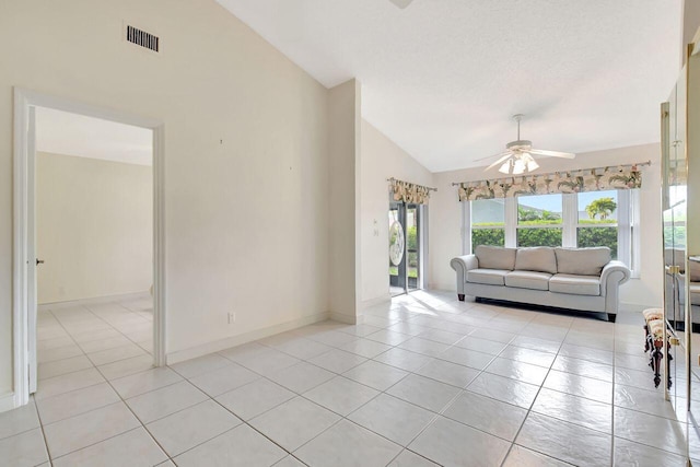 unfurnished living room with visible vents, high vaulted ceiling, light tile patterned floors, baseboards, and ceiling fan