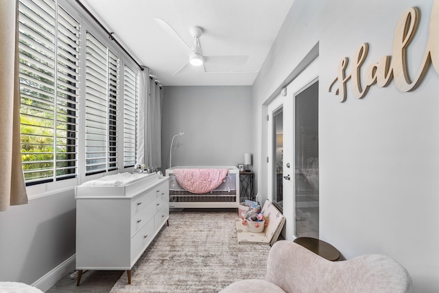 bedroom featuring baseboards and ceiling fan