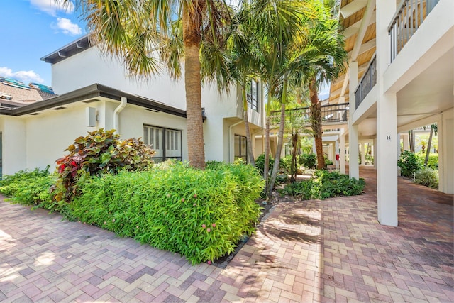 doorway to property featuring stucco siding