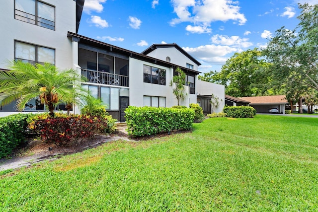 exterior space with a yard and stucco siding