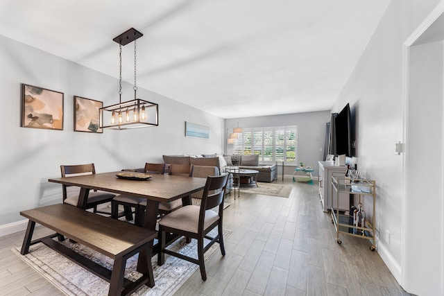 dining space featuring wood finished floors and baseboards