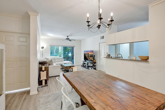 dining space featuring crown molding, ceiling fan with notable chandelier, visible vents, and wood finish floors