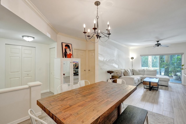 dining area with light wood finished floors, crown molding, and baseboards