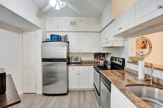 kitchen with under cabinet range hood, appliances with stainless steel finishes, white cabinets, and a sink