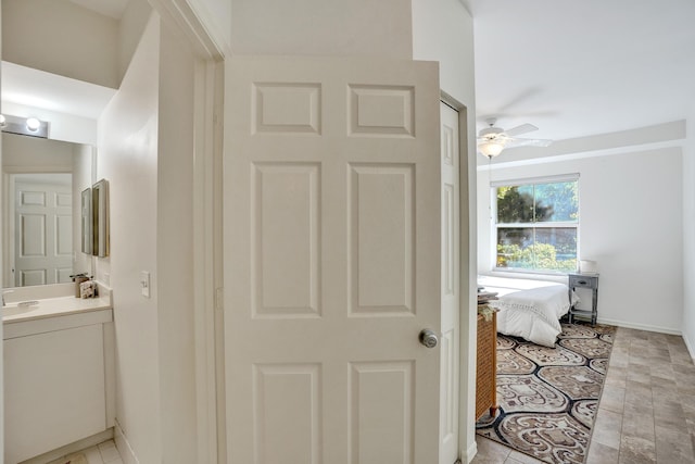 bathroom featuring baseboards, vanity, and a ceiling fan