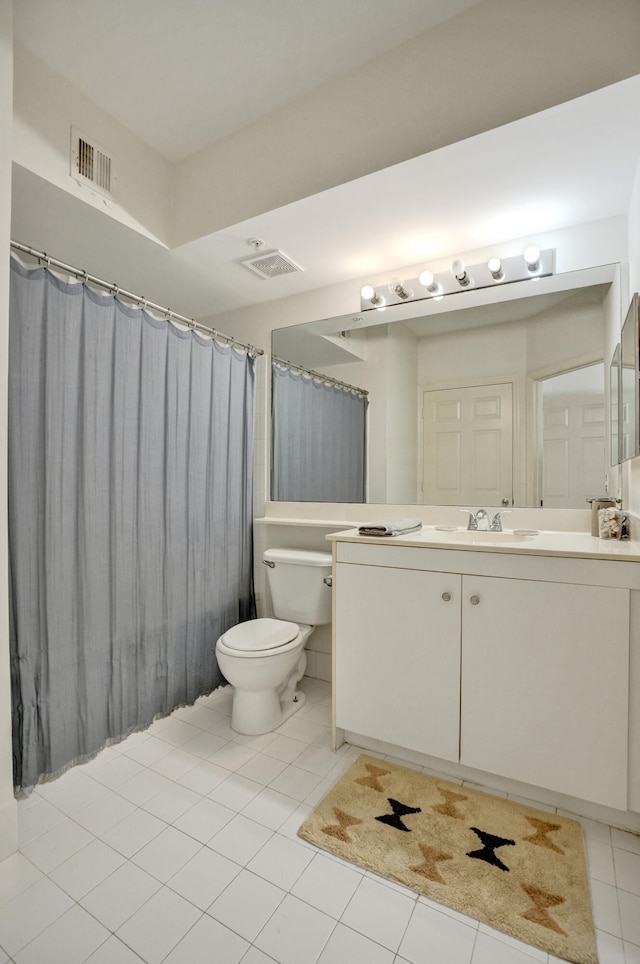 bathroom featuring vanity, toilet, visible vents, and tile patterned flooring