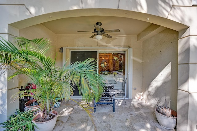 property entrance featuring a patio area and a ceiling fan