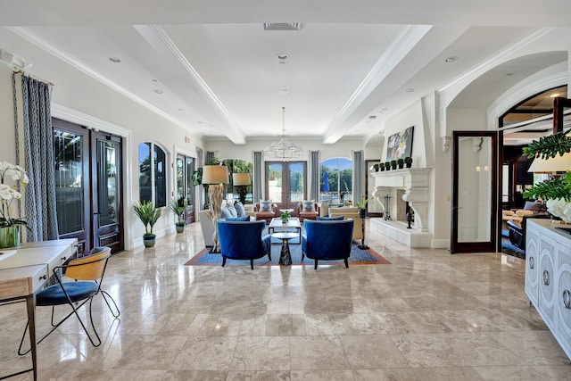 living room featuring baseboards, visible vents, a fireplace with raised hearth, ornamental molding, and french doors