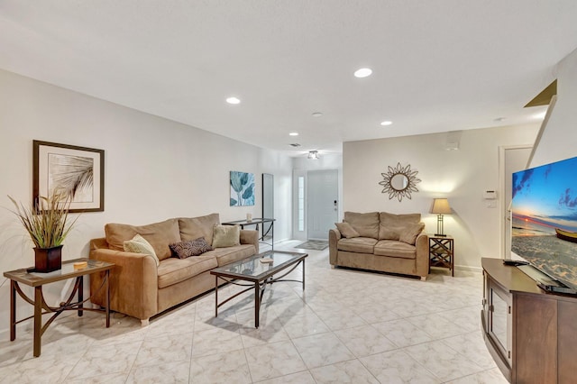 living area featuring recessed lighting and baseboards