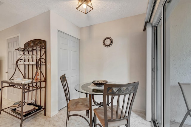 dining room with a textured ceiling