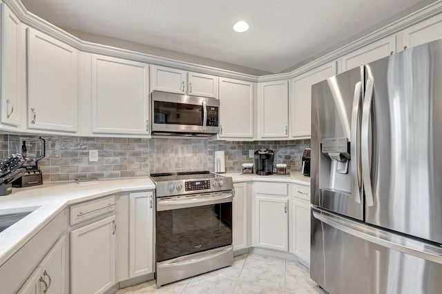 kitchen with backsplash, appliances with stainless steel finishes, light countertops, and marble finish floor