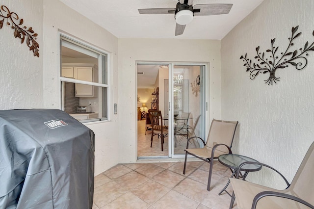 view of patio featuring a grill and a ceiling fan