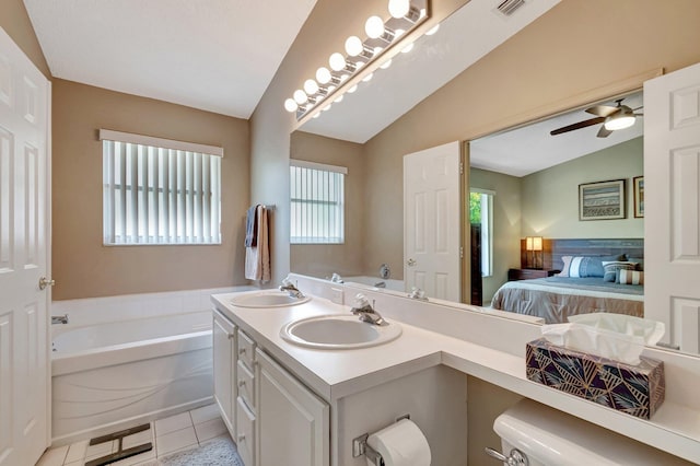 ensuite bathroom with a sink, tile patterned flooring, vaulted ceiling, a bath, and connected bathroom