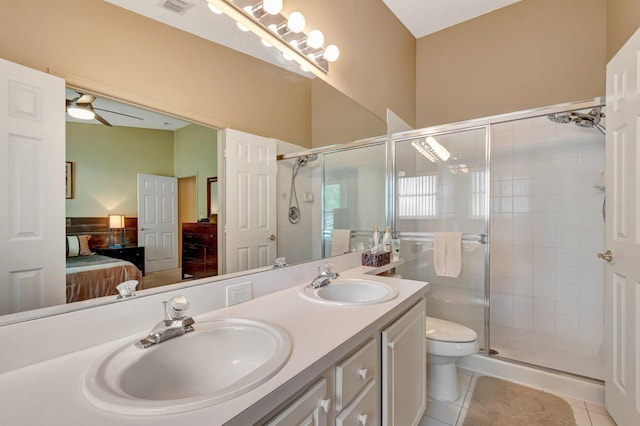 bathroom featuring a sink, a shower stall, ensuite bathroom, and tile patterned flooring