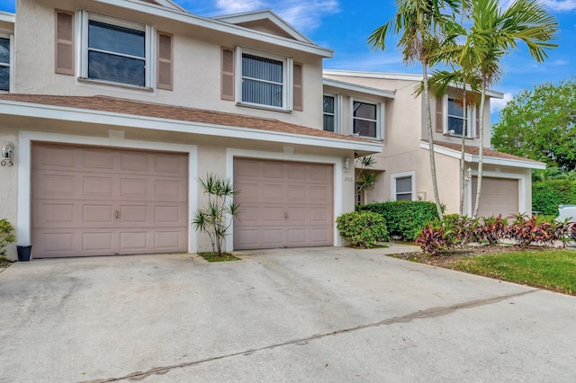 multi unit property with stucco siding and driveway