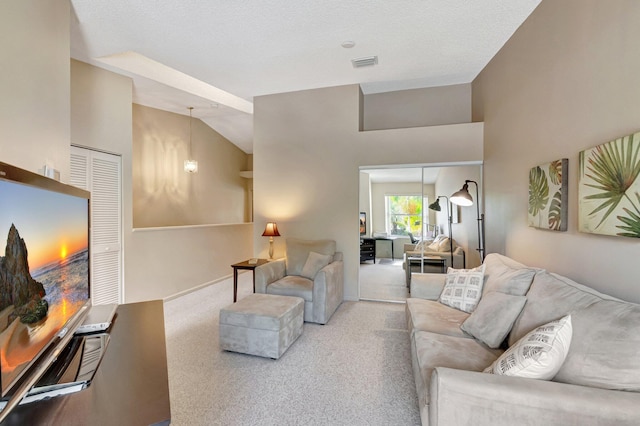 carpeted living area featuring lofted ceiling and visible vents