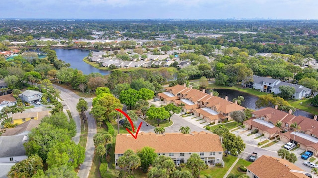 drone / aerial view with a residential view and a water view