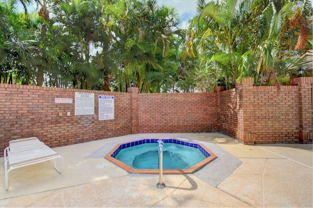 view of pool featuring a patio area, a community hot tub, and fence