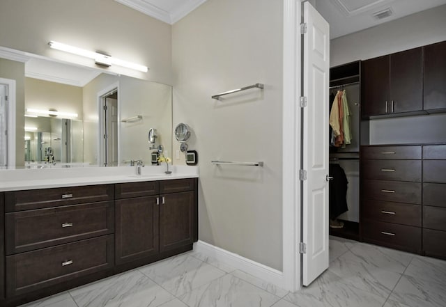 full bath featuring vanity, baseboards, marble finish floor, and ornamental molding