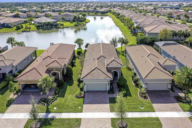 drone / aerial view with a residential view and a water view