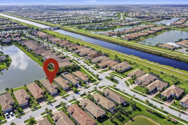 drone / aerial view featuring a residential view and a water view