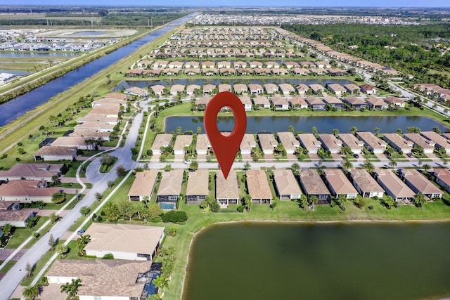 birds eye view of property featuring a residential view and a water view