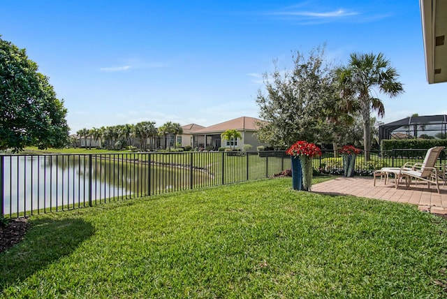 view of yard with a fenced backyard, a patio, and a water view