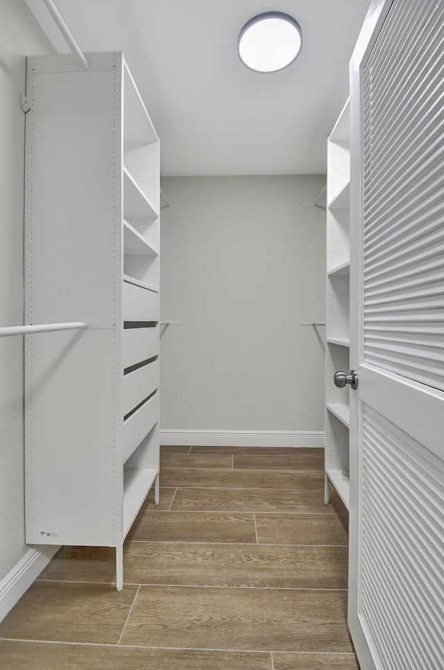 spacious closet featuring wood finish floors