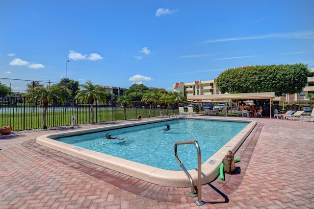 community pool featuring a patio area and fence