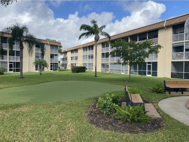 view of property's community with a lawn