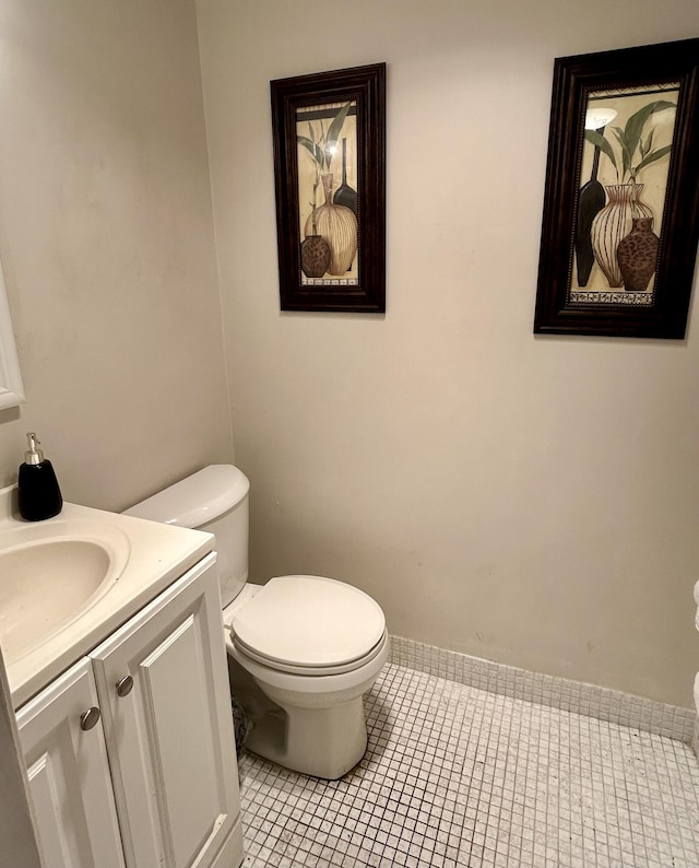 bathroom featuring tile patterned floors, toilet, and vanity