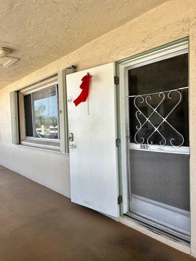 property entrance featuring stucco siding