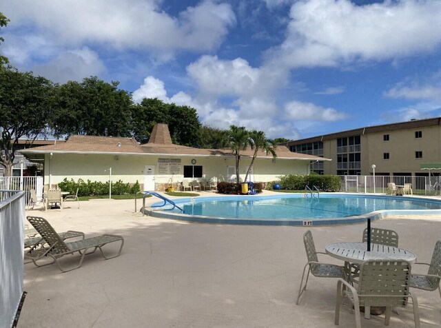 pool featuring a patio and fence