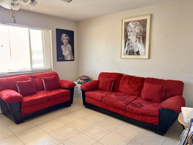 living room with tile patterned floors and a textured ceiling