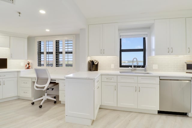 kitchen featuring a sink, backsplash, dishwasher, and white cabinets