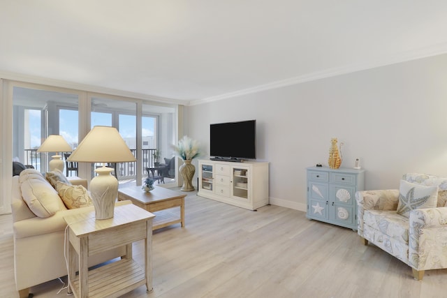 living room featuring baseboards, plenty of natural light, light wood-style floors, and ornamental molding