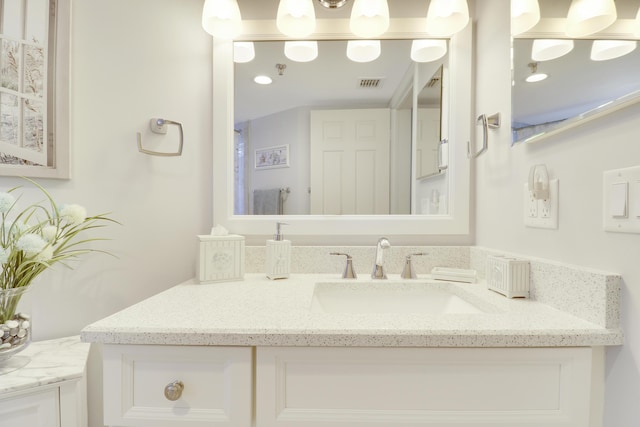 bathroom featuring vanity and visible vents