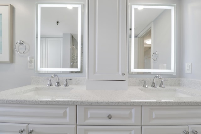 full bath with a sink and double vanity