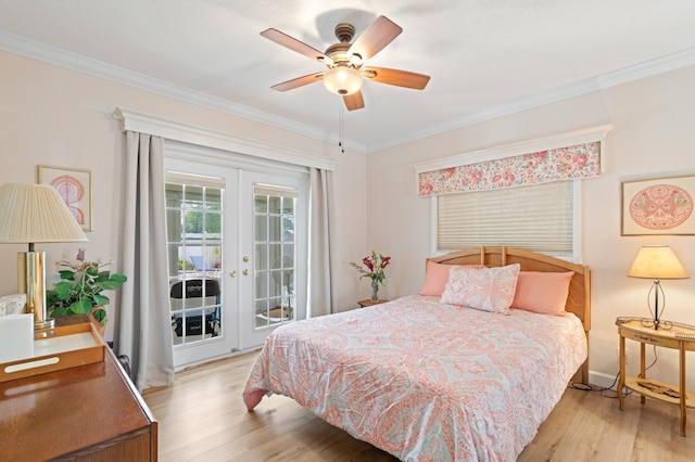 bedroom featuring access to exterior, crown molding, french doors, and light wood-style flooring