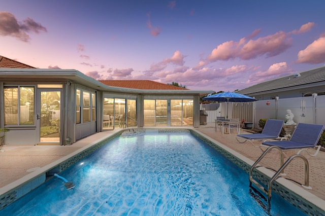 view of swimming pool with a fenced in pool, a patio, and fence