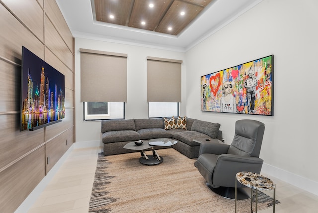 living room featuring a raised ceiling, recessed lighting, and baseboards