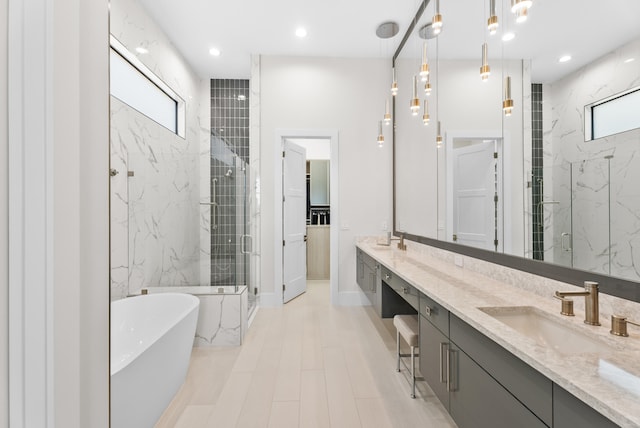 full bath with a soaking tub, plenty of natural light, a shower stall, and a sink