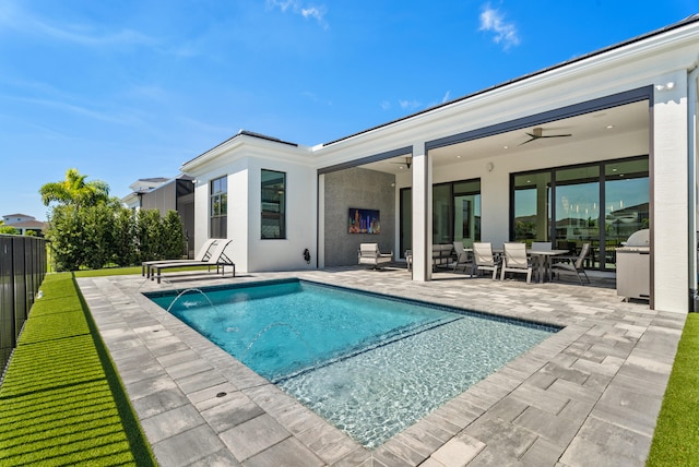 view of pool featuring a ceiling fan, a fenced in pool, a patio area, and fence