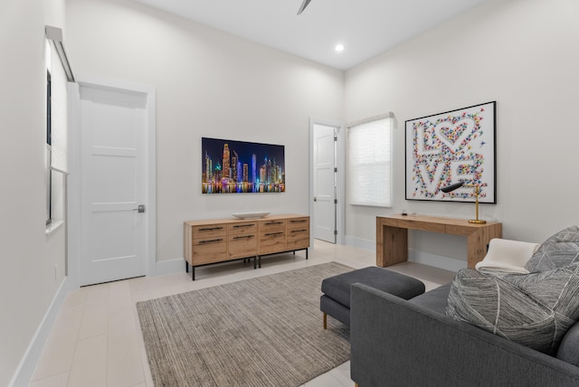 living area featuring recessed lighting and baseboards