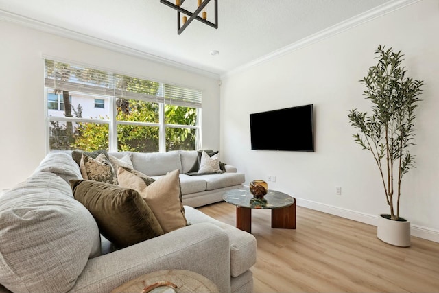 living room with light wood-style floors, baseboards, and ornamental molding