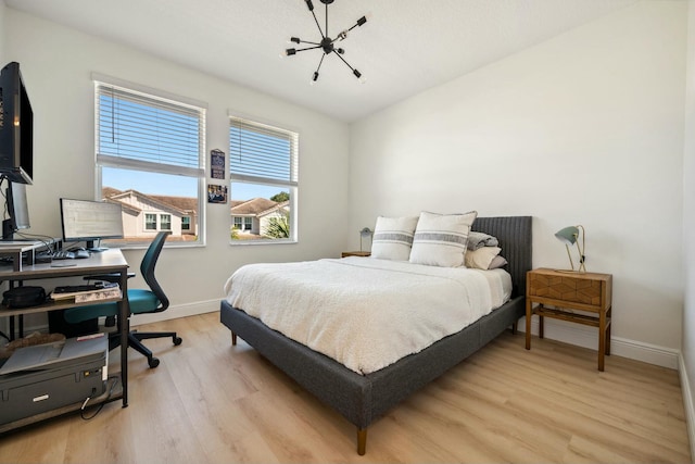 bedroom with baseboards and light wood-style flooring