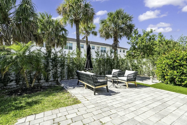 view of patio featuring outdoor lounge area and fence