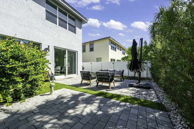 view of patio / terrace with an outdoor living space and fence